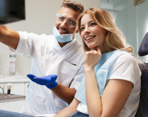 Dentist and patient looking at chairside computer monitor