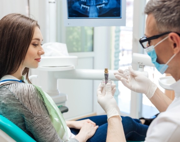 Dentist and patient reviewing the dental implant process